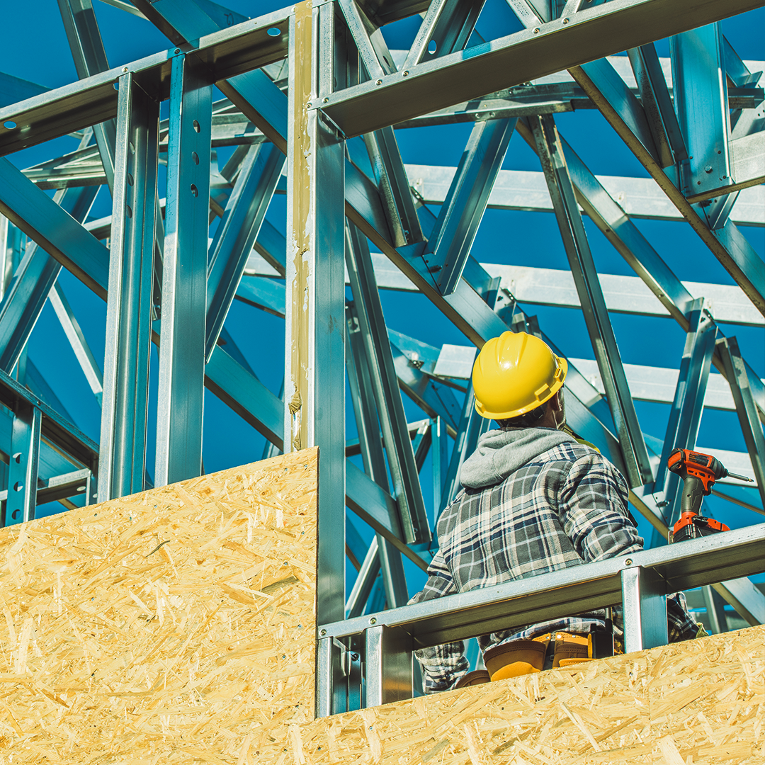 Construction worker with a yellow helmet at a building site