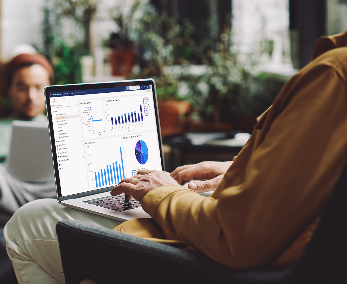 Person using a laptop with financial dashboards