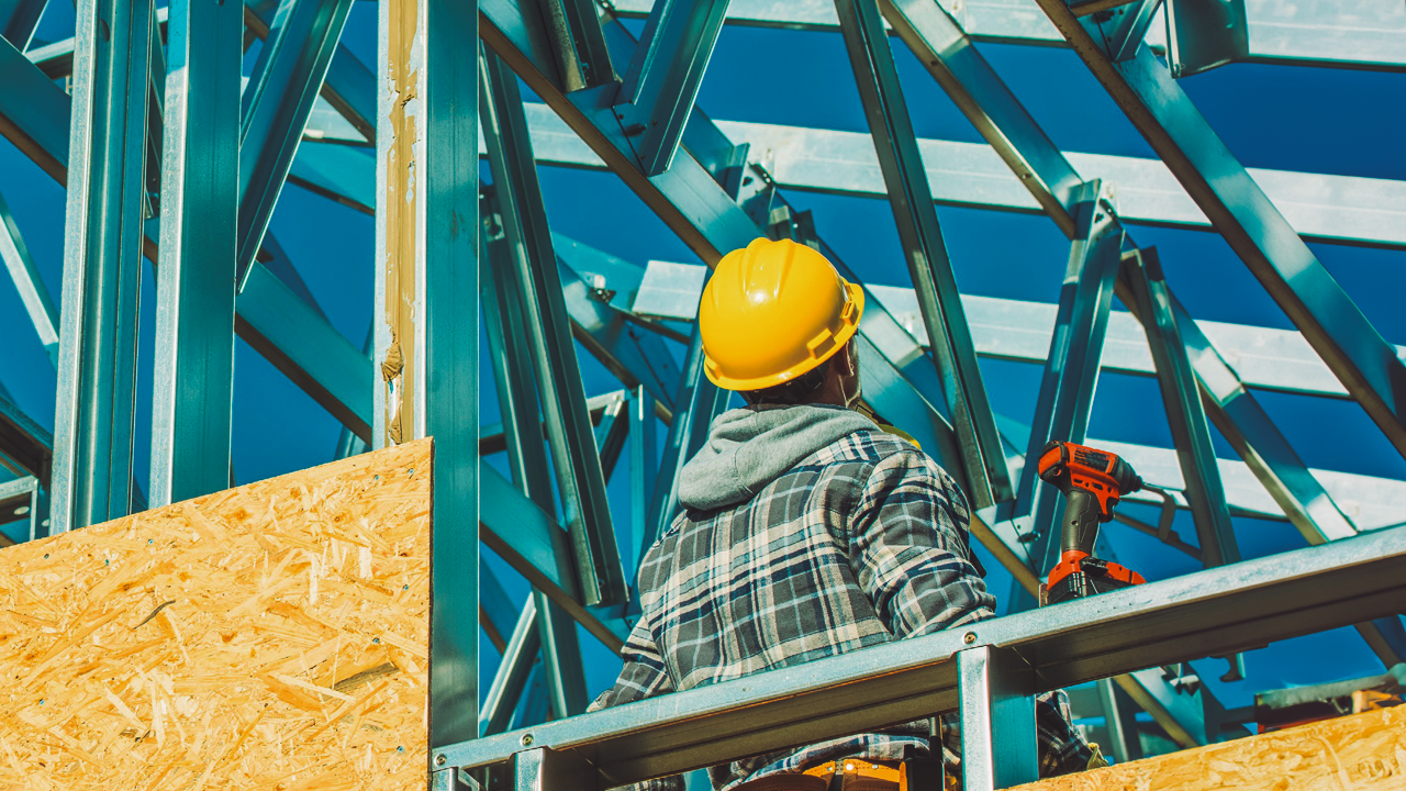 A man wearing safety clothing is working on a construction site.
